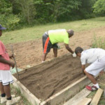 a group of people standing in the dirt