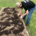 a man that is standing in the dirt