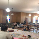 people quilting inside of a church