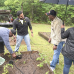 a group of people standing in a garden