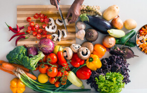 person chopping colorful vegetables 